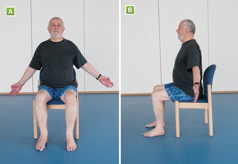 A man sits straight, shoulders back and has his arms at 45 degree angle 